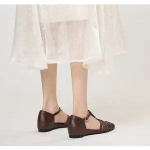 Side view of vintage brown woven T-strap sandals with square toe and low wedge heel
