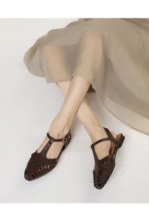 Detailed view of French vintage pointed-toe woven sandals with T-strap on model