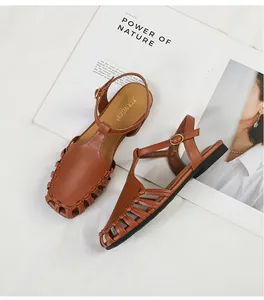 Elegant French retro brown leather woven sandals with T-strap and gold buckle details