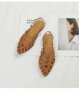 Elegant brown Roman woven flat sandals with strappy hollow design and pointed toe.