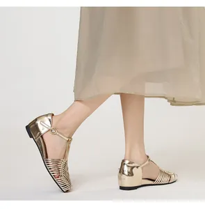 Side view detail of retro golden woven sandals with T-strap buckle and square toe design