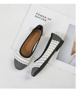 Vista dettagliata di ballerine intrecciate bianche e nere con elegante design traforato