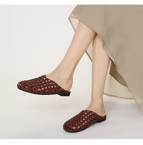 Primer plano de mules vintage trenzados en color marrón con diseño calado