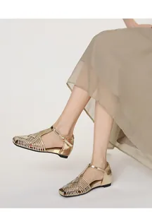 Elegant detail view of retro gold woven T-strap sandals with a stylish square toe design