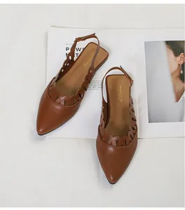 Elegant vintage pointed-toe flats with brown hollow scalloped edges and slingback strap details