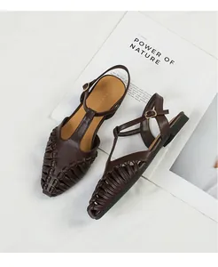 Detailed shot of brown French vintage woven T-strap sandals featuring pointed toe design