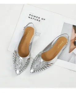 Elegant silver woven pointed-toe slingback flats displayed on a lifestyle magazine