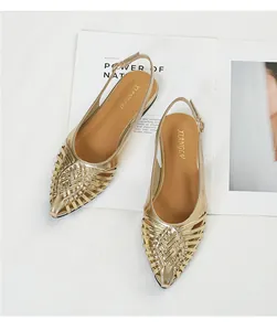 Detailed view of the intricate gold woven texture on pointed-toe slingback sandals.