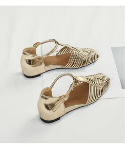 Detail view of vintage gold woven sandals with T-strap buckle and square toe