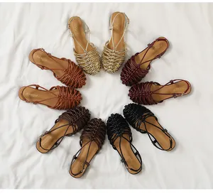 Overhead view showing multiple colors of vintage hand-woven flat Roman sandals for women