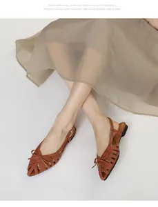 Detailed view of vintage brown woven pointed-toe sandals featuring a delicate bow detail