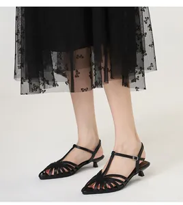 Black pointed-toe kitten heel sandals with woven cage design and elegant ankle strap