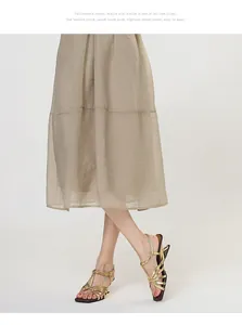 Detail view of vintage gold strappy sandals with square toe and unique shaped heel