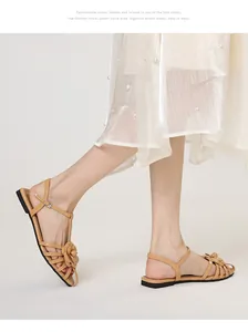 Close-up of fairy-style flat sandals with camellia flower and ankle strap