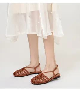 Detailed view of brown hand-woven closed-toe Roman sandals with adjustable ankle strap