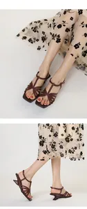 Close-up of vintage cross-strap sandals with architectural heels and square toe design