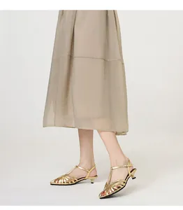 Elegant gold woven kitten heel sandals for women with pointed toe and ankle strap.