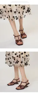 Detailed view of vintage cross-strap sandals with square toe and irregular heel