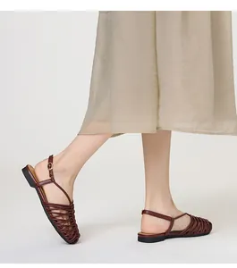 Women's handmade woven closed-toe Roman sandals featuring a flat heel and retro buckle strap