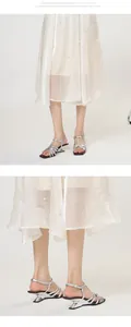 Detailed view of silver strappy sandals with unique sculptural heels and square toe.