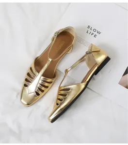 Elegant gold metallic T-strap flat sandals with a retro hollowed-out square toe design