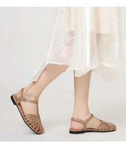 Vintage brown cutout T-strap flat sandals styled with a white pearl-accented skirt