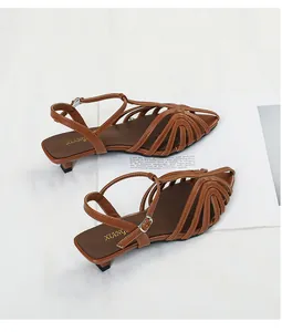 Detailed top view of brown woven pointed-toe kitten heel sandals with ankle strap