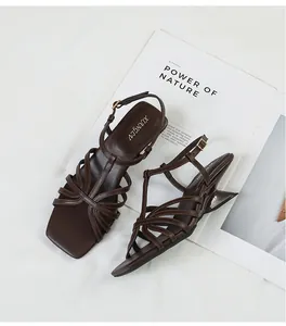 Close-up of vintage brown strappy sandals with square toe and unique geometric heels