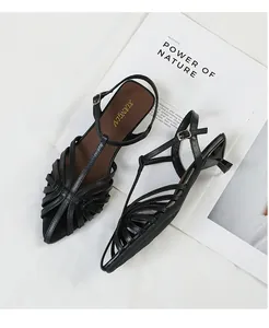 Detailed top view of black pointed-toe kitten heel sandals with elegant strappy design