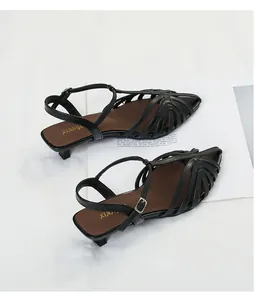 Detailed view of elegant black strappy kitten heel sandals with pointed toe design