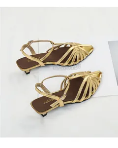 Elegant gold woven pointed-toe kitten heel sandals with an adjustable ankle strap