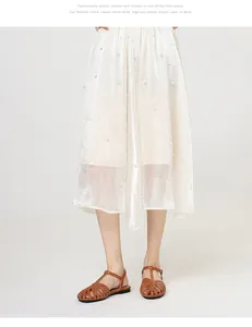 Detail view of vintage brown T-strap hollowed-out flat sandals with a pearl skirt