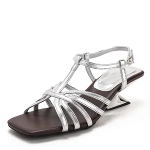 Elegant silver criss-cross strap sandals with square toe and unique sculptural high heel