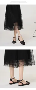 Detail view of black retro Roman woven flat sandals with ankle strap closure