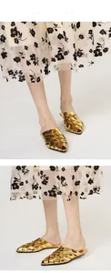 Detailed view of the gold metallic braided pattern on these elegant pointed-toe mules