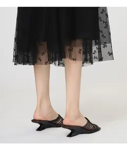 Detail view of French style mule sandals with irregular sculptural heel and radial straps