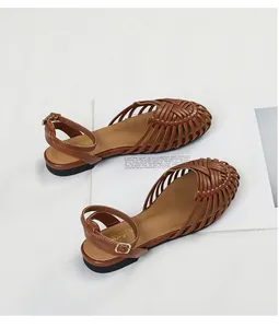 Detail view of retro brown woven cage sandals with adjustable ankle buckle strap