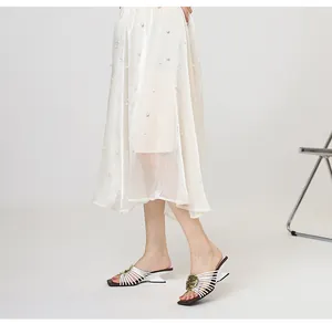 Detail view of French metal style irregular heel sandals with white radiating straps