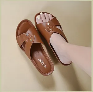 Detailed close-up view of comfortable brown cross-strap wedge sandals worn on foot