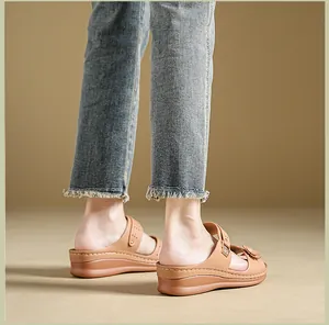Detailed view of women's brown floral wedge platform sandals with retro stitching design.