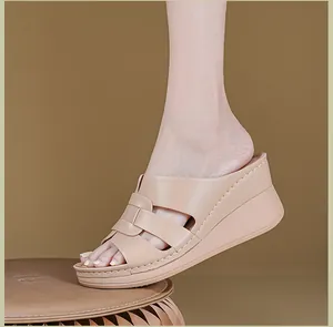 Detailed side view of beige wedge sandals for women featuring elegant stitched strap design