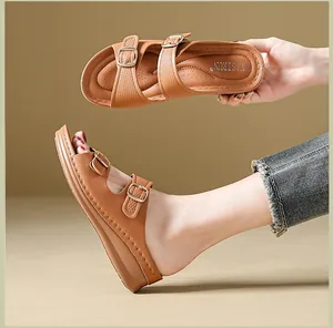 Detail view of brown wedge sandals with adjustable buckle straps and breathable insole.