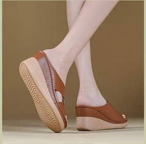 Detailed view of women's brown platform wedge sandals featuring decorative stitching.