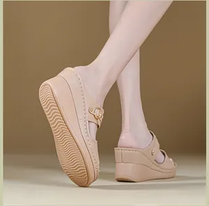 Detailed close-up of beige wedge sandals for women featuring elegant stitching patterns