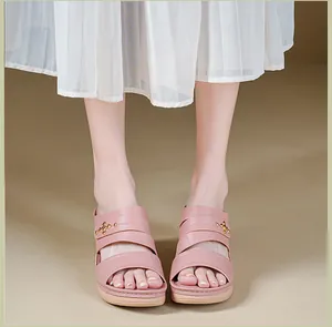 Close-up front view of stylish pink wedge sandals with metallic star accents on model.