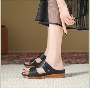 Detailed side view of black wedge sandals for women featuring elegant hollow cutout pattern