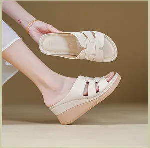 Close-up showing the comfortable wedge heel and textured inner sole of beige sandals