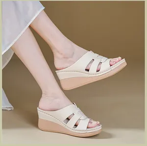 Side view of beige platform wedge sandals with stitched strap details for women