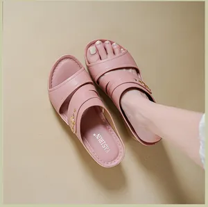 Detailed view of pink wedge sandals for women featuring stylish stitched cross straps