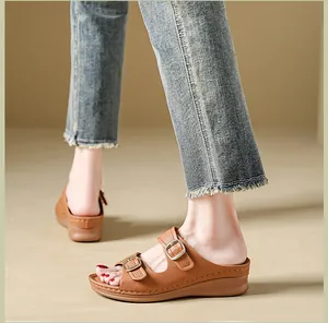 Close-up side view of brown platform wedge sandals with adjustable buckle straps